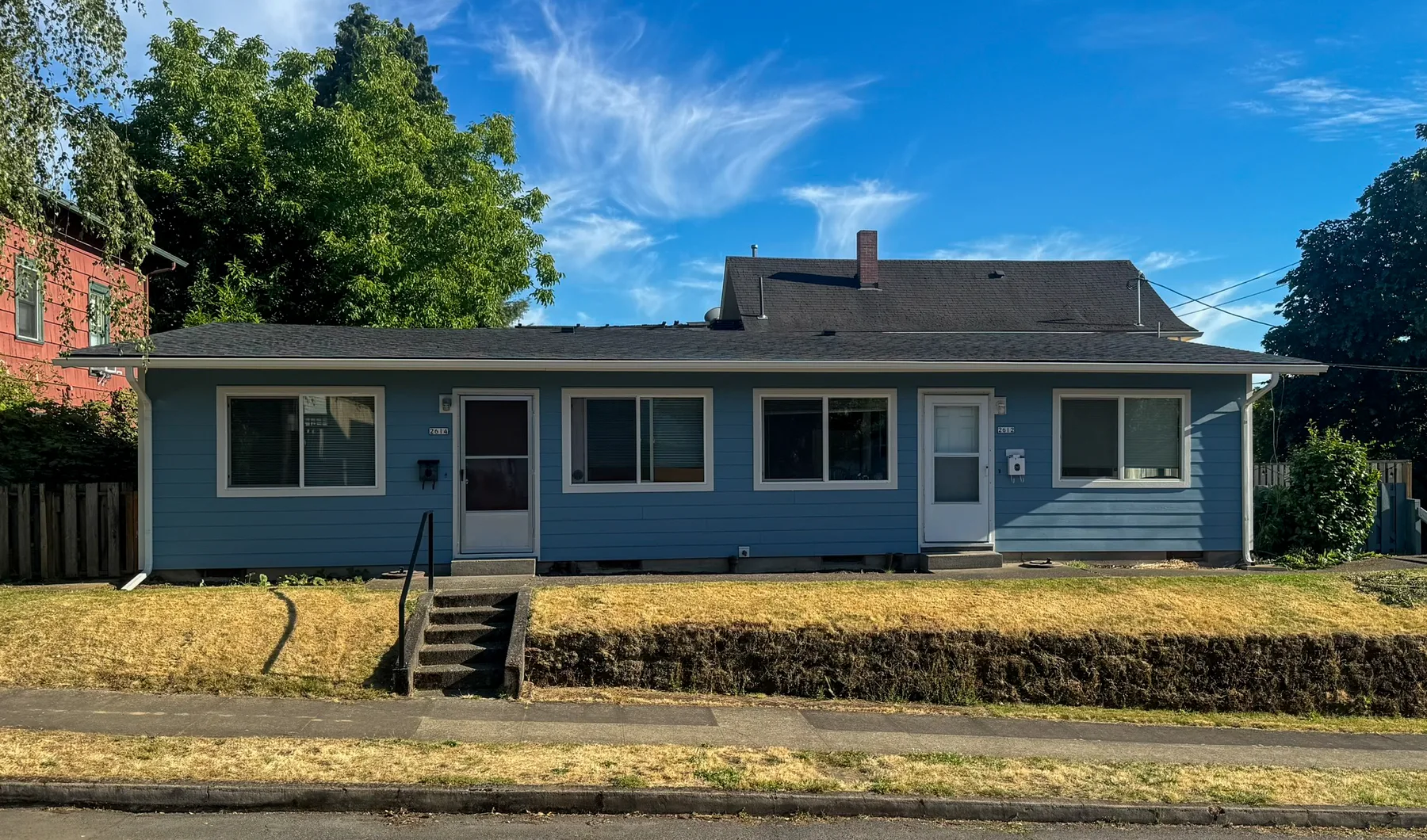 Completed Portland exterior painting project with blue siding and white trim